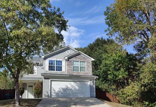 a front view of a house with a garden