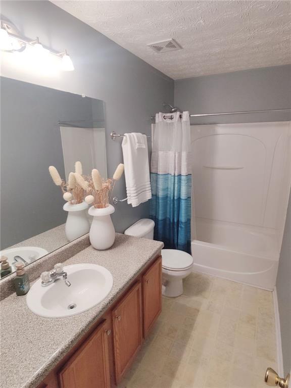 1600 Keystone Drive Conley, GA 30288 - Photo 12 of 14 a bathroom with a granite countertop sink a toilet and shower