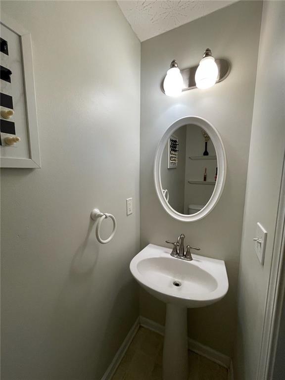 1600 Keystone Drive Conley, GA 30288 - Photo 13 of 14 a bathroom with a sink and a mirror