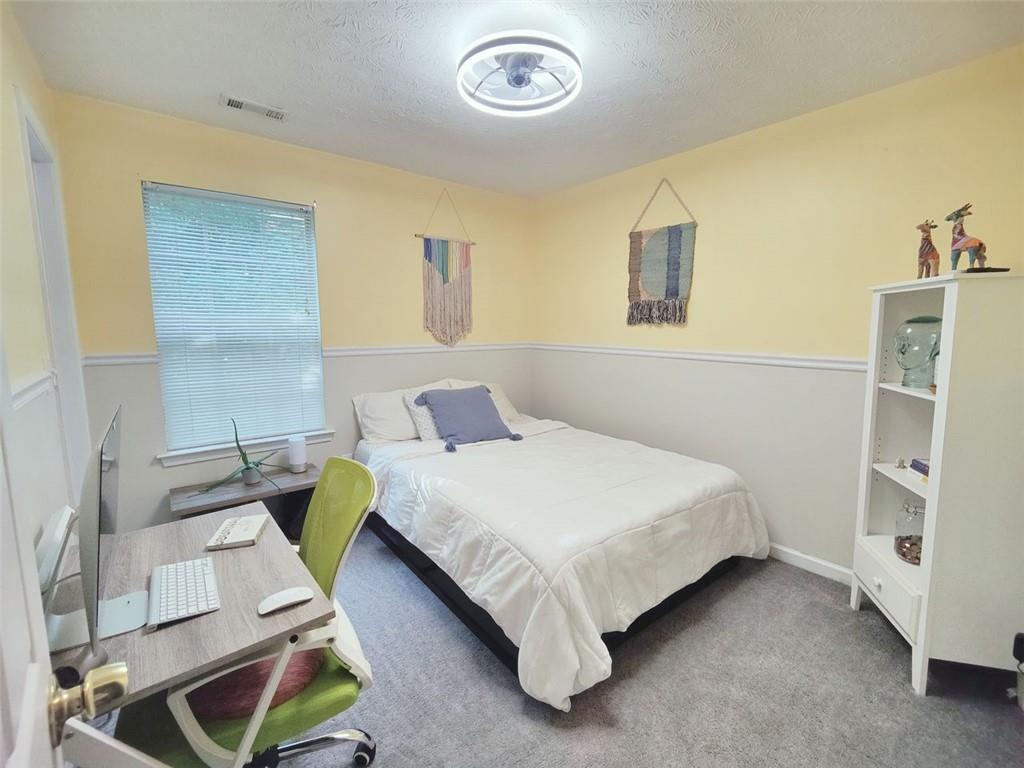 1600 Keystone Drive Conley, GA 30288 - Photo 7 of 14 a bedroom with a bed and a window