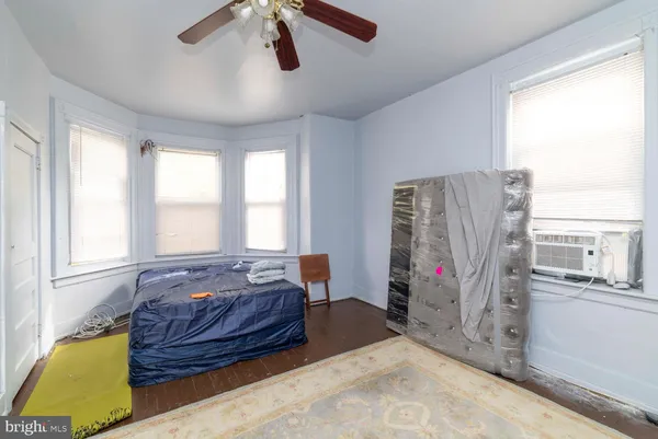 a bed sitting in a room next to a window
