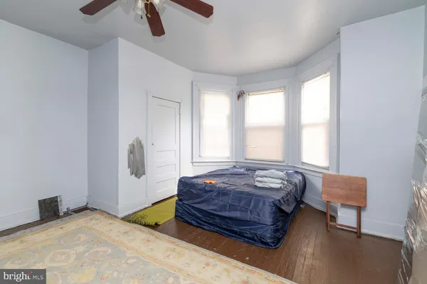 a living room with a bed furniture and a window