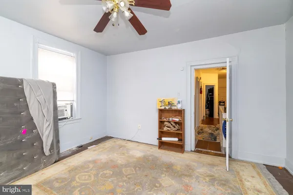 an empty room with windows and closet