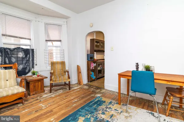 a living room with furniture a wooden floor and a window