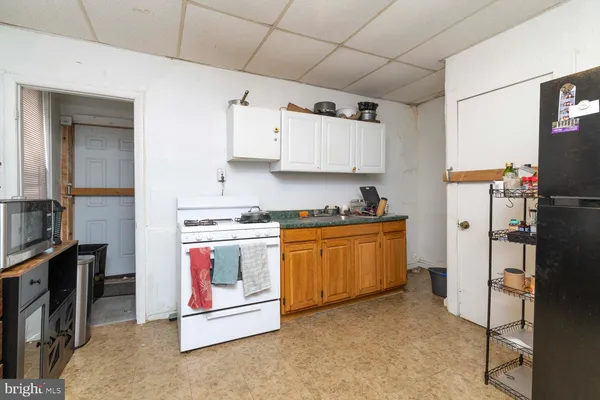a kitchen with stainless steel appliances granite countertop a stove and a refrigerator