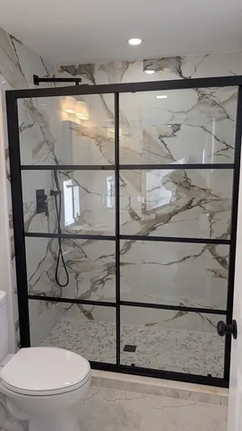 a bathroom with a toilet and a shower