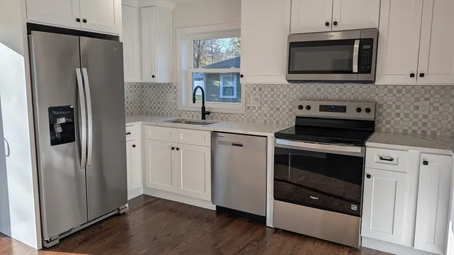 a kitchen with stainless steel appliances and wooden cabinets