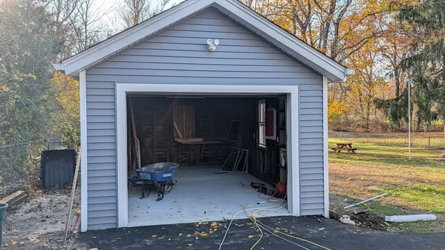 a view of a small house with backyard