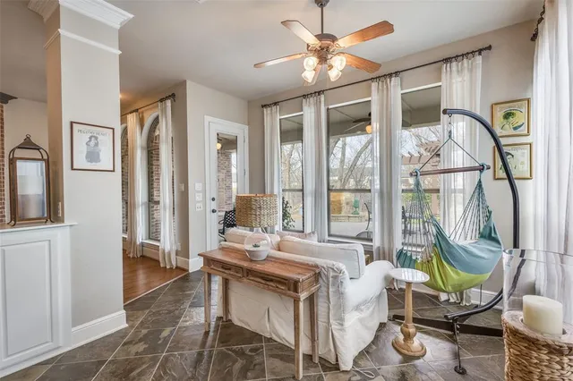 a living room with furniture a fireplace and a chandelier