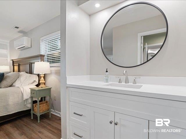 4650 Wiggins Lane Wilmer, AL 36587 - Photo 20 of 66 Bathroom with vanity, dark wood-style flooring, and a wall mounted AC