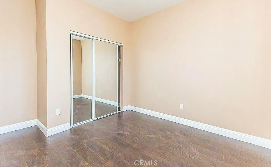 229 East 84th Street, Unit 229 Los Angeles, CA 90003 - Photo 4 of 5 an empty room with closet and sliding door