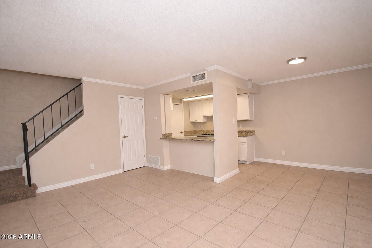 4043 West Wonderview Road Phoenix, AZ 85019 - Photo 2 of 10 a view of an empty room and a kitchen