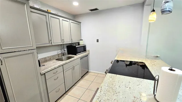 a kitchen with a sink and cabinets