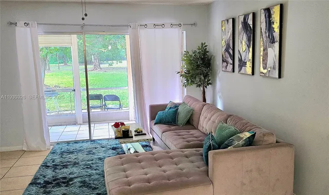 a living room with furniture and a large window