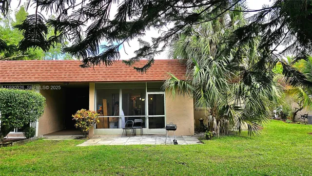 a front view of a house with a garden and yard