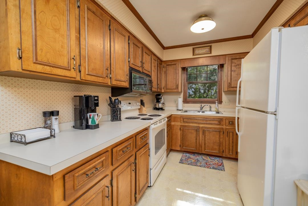 6509 Woodshire Place Raleigh, NC 27612 - Photo 12 of 30 a kitchen with sink cabinets and window