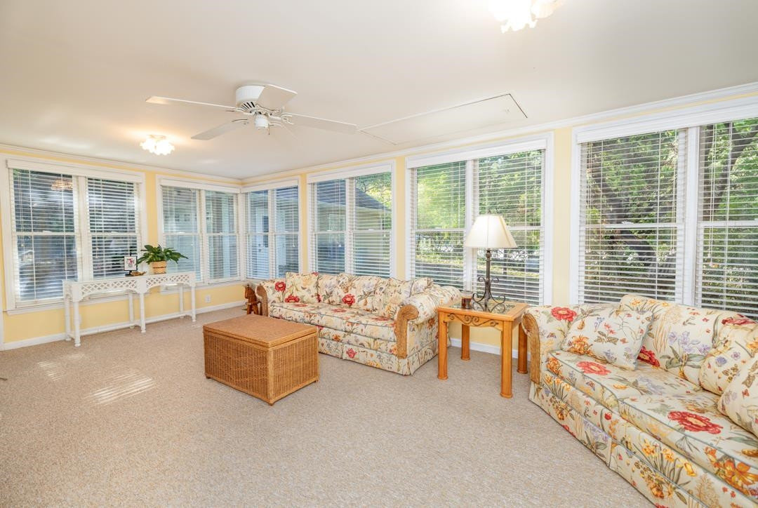 6509 Woodshire Place Raleigh, NC 27612 - Photo 19 of 30 a living room with furniture and large windows