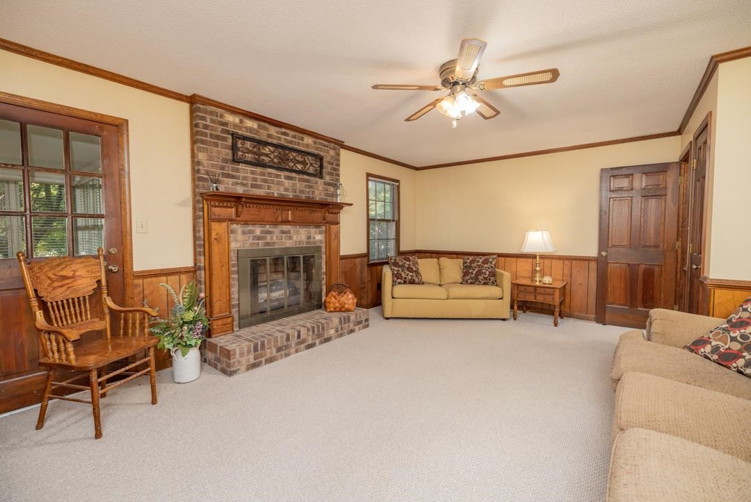 6509 Woodshire Place Raleigh, NC 27612 - Photo 20 of 30 a living room with furniture and a fireplace