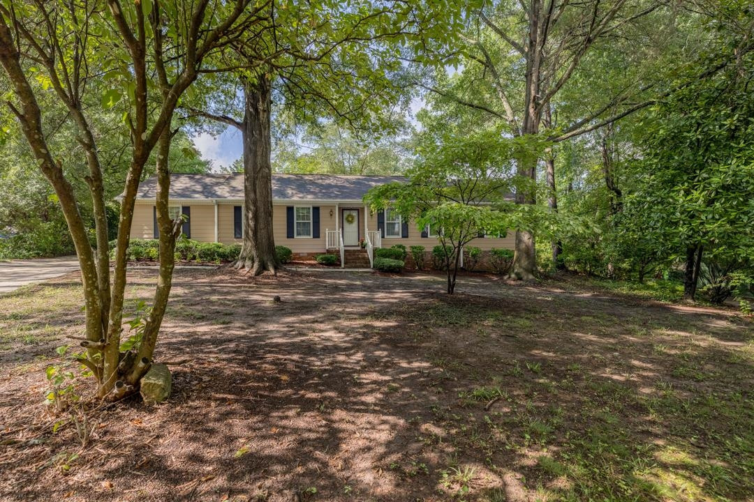 6509 Woodshire Place Raleigh, NC 27612 - Photo 2 of 30 a front view of a house with garden