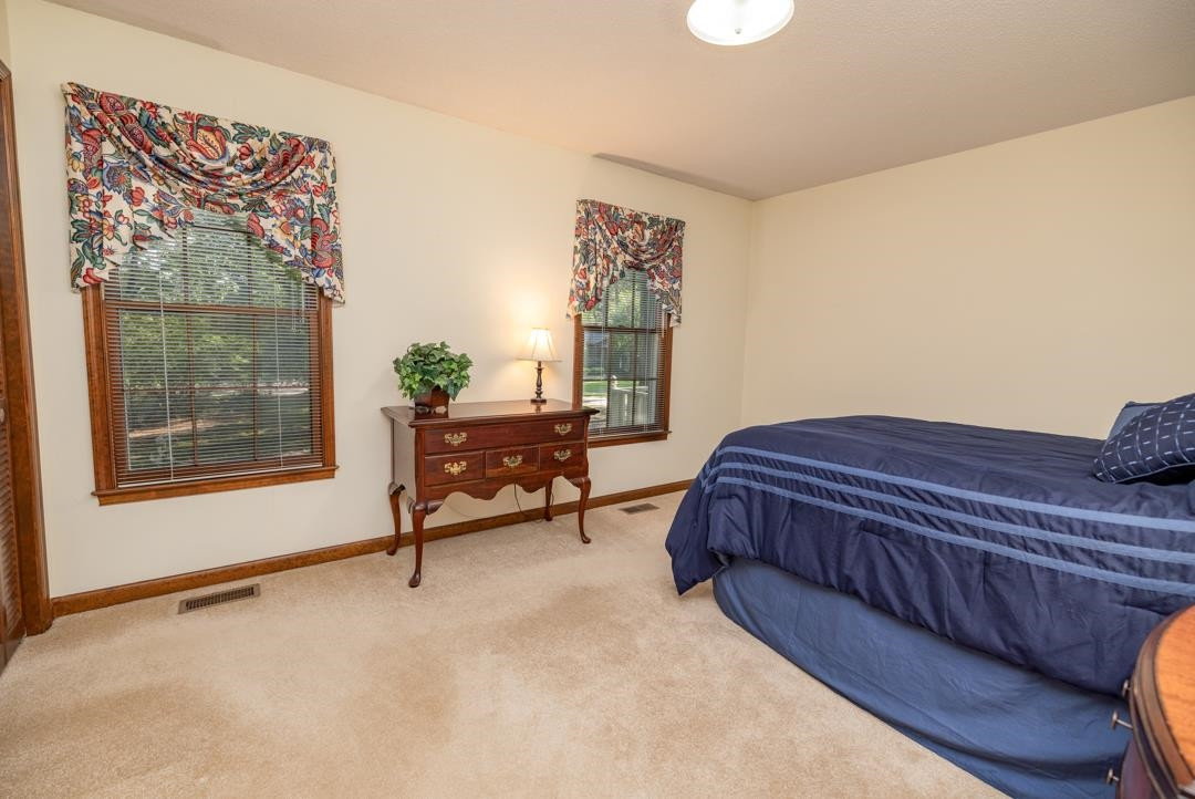 6509 Woodshire Place Raleigh, NC 27612 - Photo 23 of 30 a spacious bedroom with a bed and window
