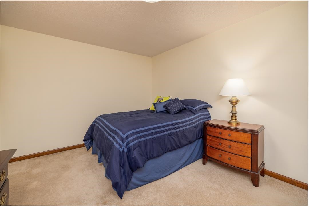 6509 Woodshire Place Raleigh, NC 27612 - Photo 24 of 30 a bedroom with a bed and a lamp on roof