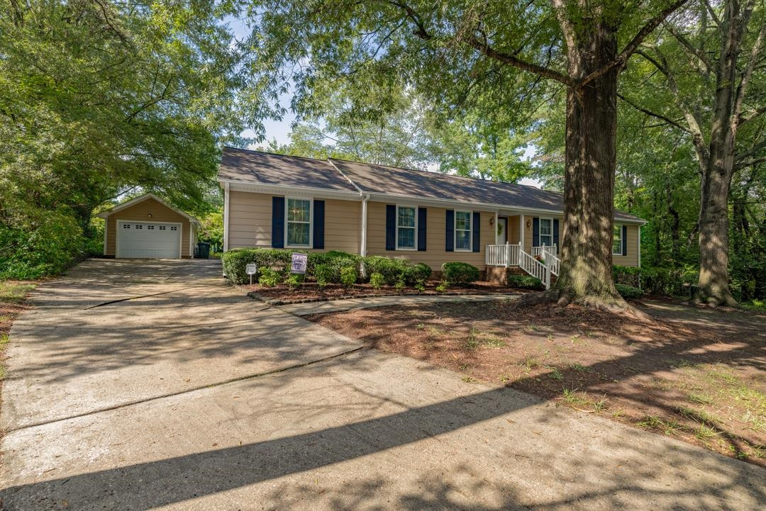 6509 Woodshire Place Raleigh, NC 27612 - Photo 3 of 30 a front view of a house with garden