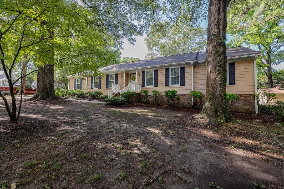 6509 Woodshire Place Raleigh, NC 27612 - Photo 7 of 30 a front view of a house with garden