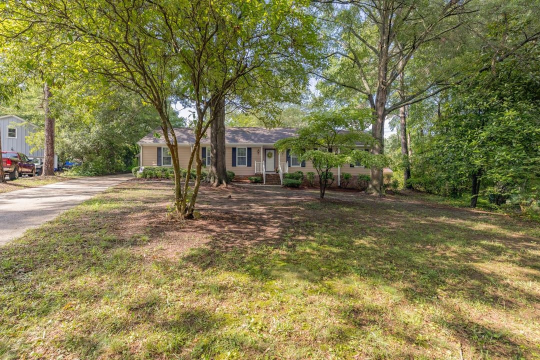 6509 Woodshire Place Raleigh, NC 27612 - Photo 8 of 30 a front view of a house with a yard