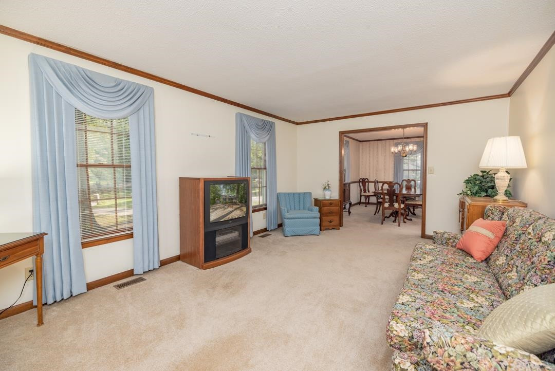 6509 Woodshire Place Raleigh, NC 27612 - Photo 9 of 30 a bedroom with furniture and a flat screen tv