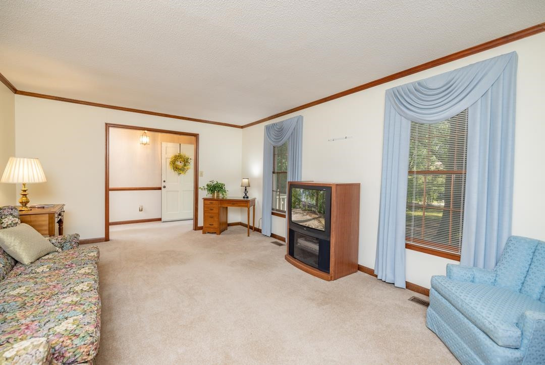 6509 Woodshire Place Raleigh, NC 27612 - Photo 10 of 30 a spacious bedroom with a bed and a couch