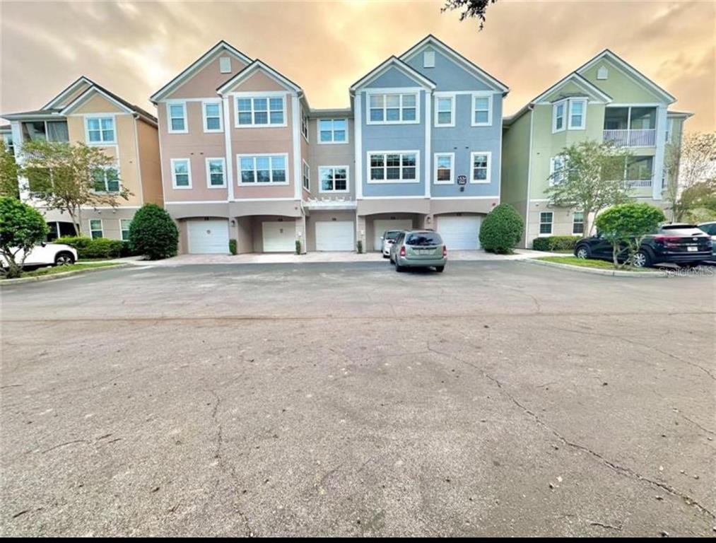 3280 Soho Street, Unit 308 Orlando, FL 32835 - Photo 1 of 45 front view of a house with a yard