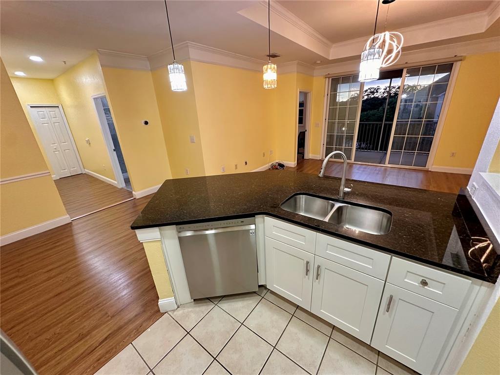3280 Soho Street, Unit 308 Orlando, FL 32835 - Photo 13 of 45 a kitchen with a sink and cabinets