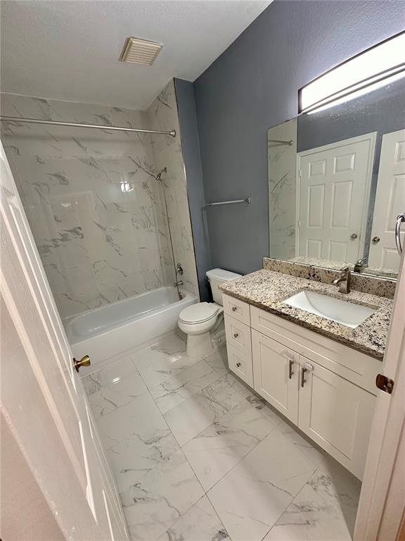 3280 Soho Street, Unit 308 Orlando, FL 32835 - Photo 29 of 45 a spacious bathroom with a granite countertop sink a toilet a mirror and shower