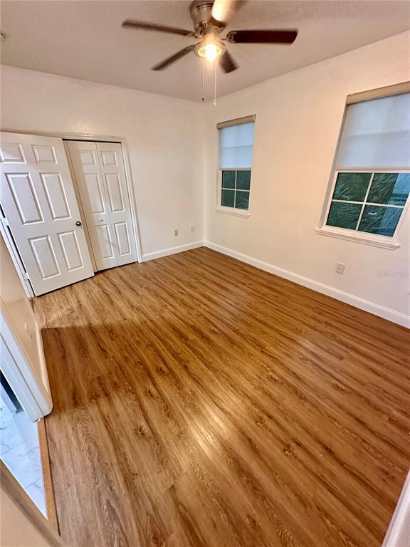 3280 Soho Street, Unit 308 Orlando, FL 32835 - Photo 31 of 45 a view of an empty room with wooden floor and a window