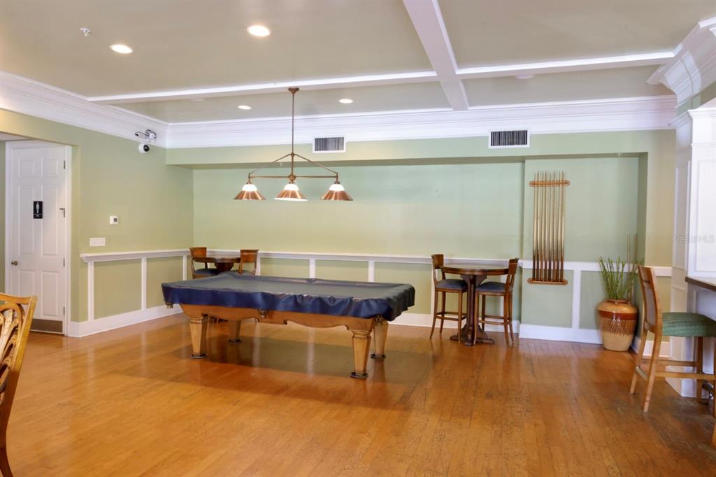 3280 Soho Street, Unit 308 Orlando, FL 32835 - Photo 44 of 45 a room with stainless steel appliances kitchen island a table and chairs in it