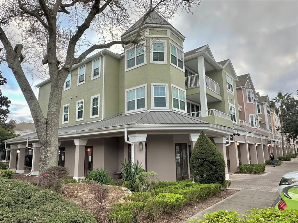 3280 Soho Street, Unit 308 Orlando, FL 32835 - Photo 7 of 45 a front view of a residential apartment building with a yard