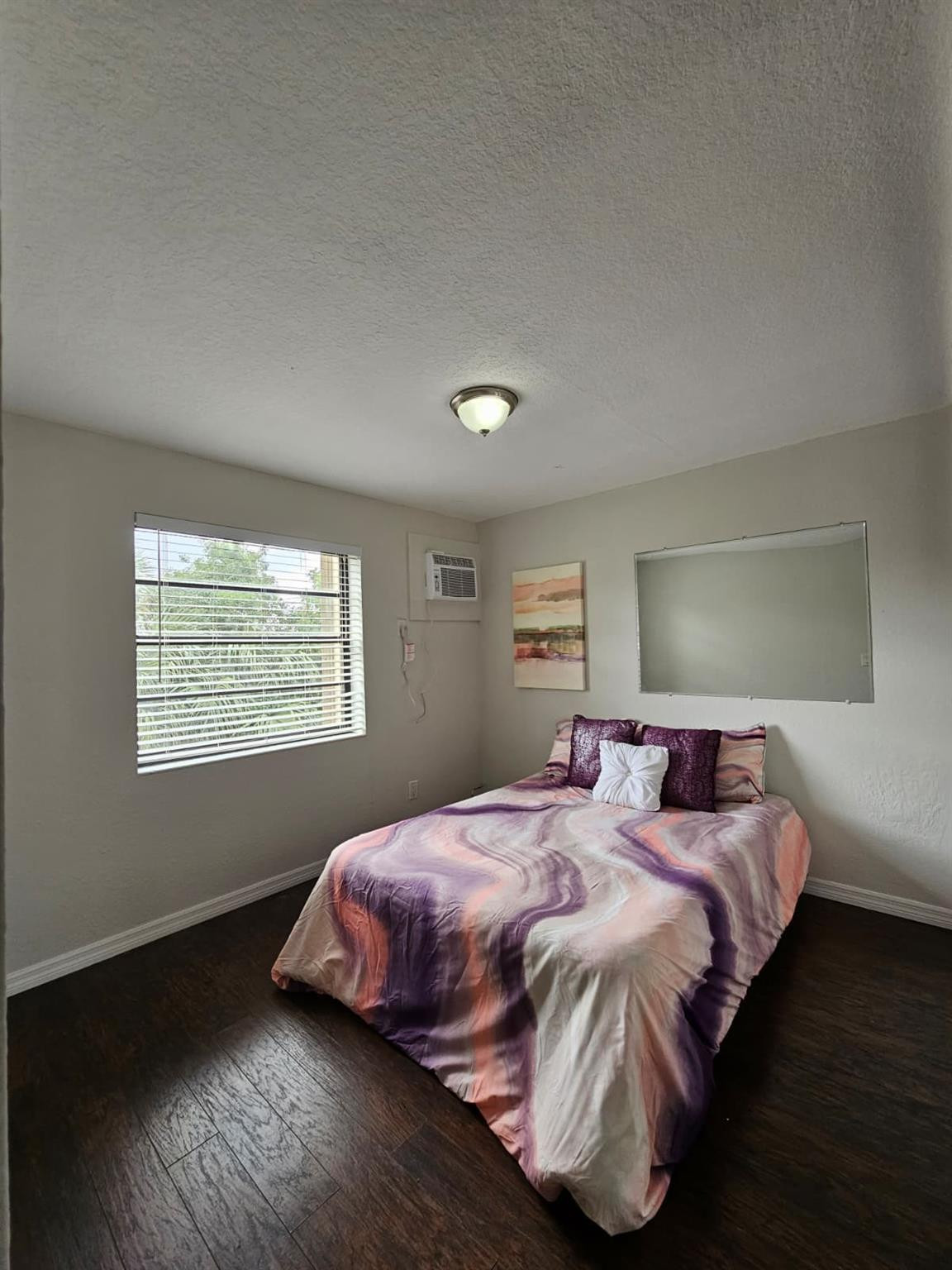 1021 Southeast Monterey Road, Unit A40 Stuart, FL 34994 - Photo 4 of 11 a bedroom with a bed and wooden floor