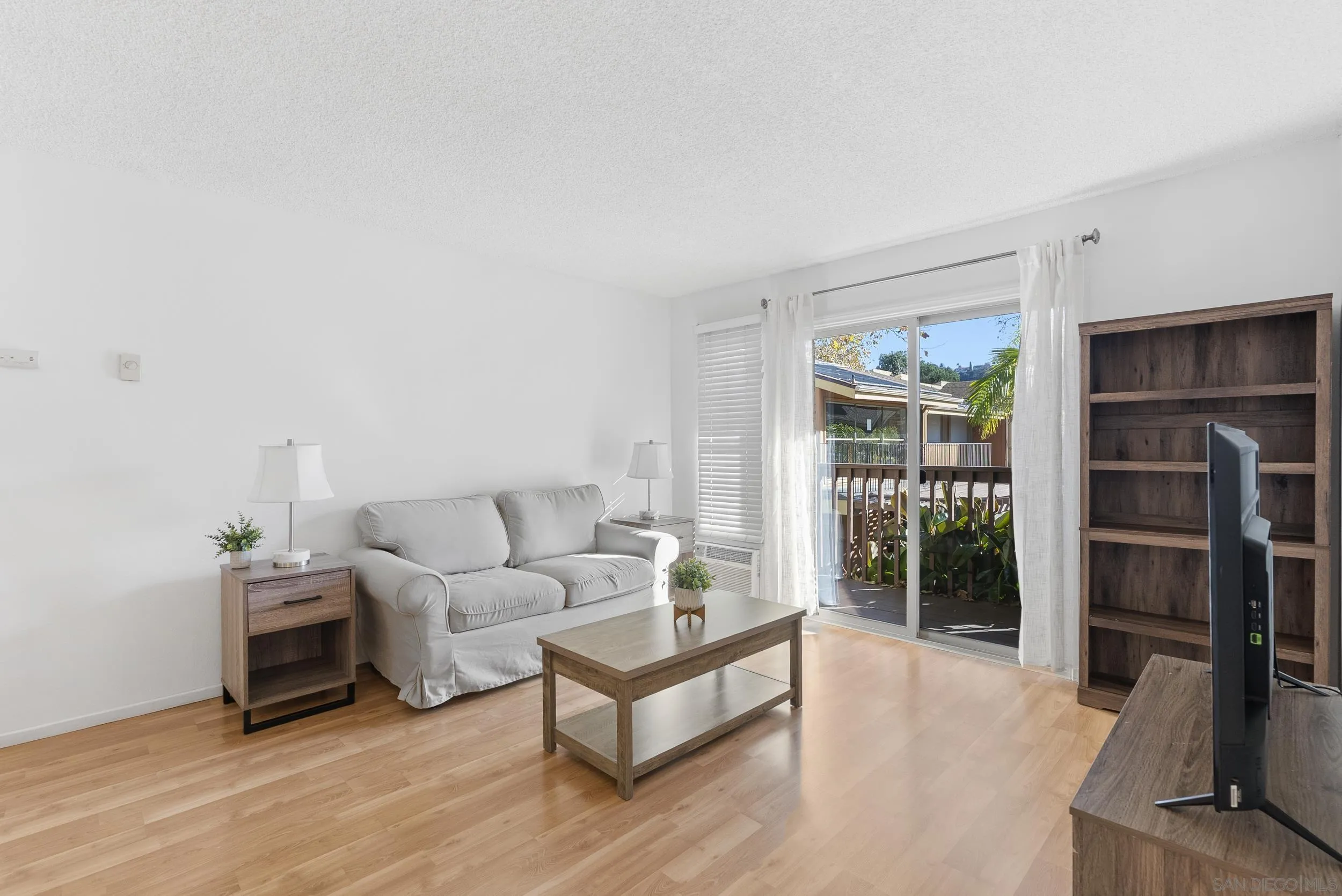 5978 Rancho Mission Road, Unit 274 San Diego, CA 92108 - Photo 9 of 23 a living room with furniture and a flat screen tv