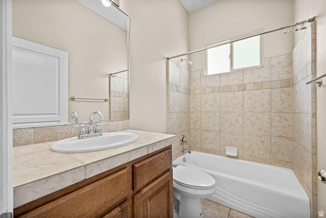 2226 East 140 South St. George, UT 84790 - Photo 11 of 20 Full bathroom featuring a single vanity with wood cabinetry, a tiled countertop, and a white oval sink