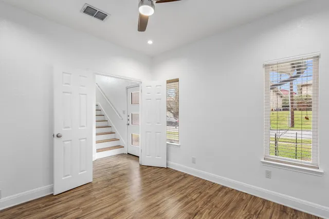 wooden floor in an empty room with a window