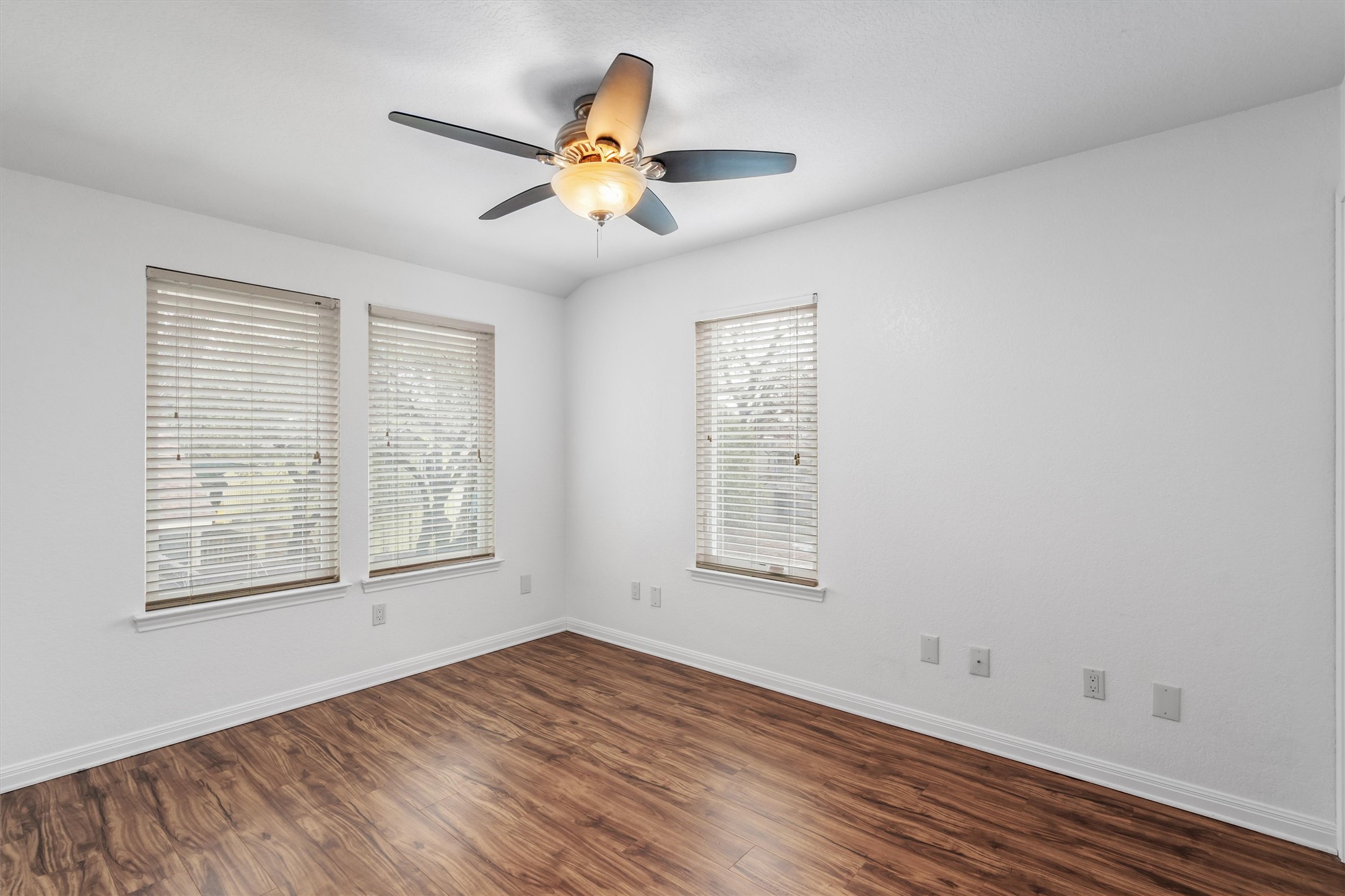 201 East 35th Street, Unit B Austin, TX 78705 - Photo 17 of 27 an empty room with wooden floor fan and windows