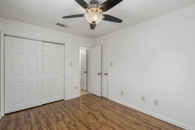 a view of empty room with wooden floor