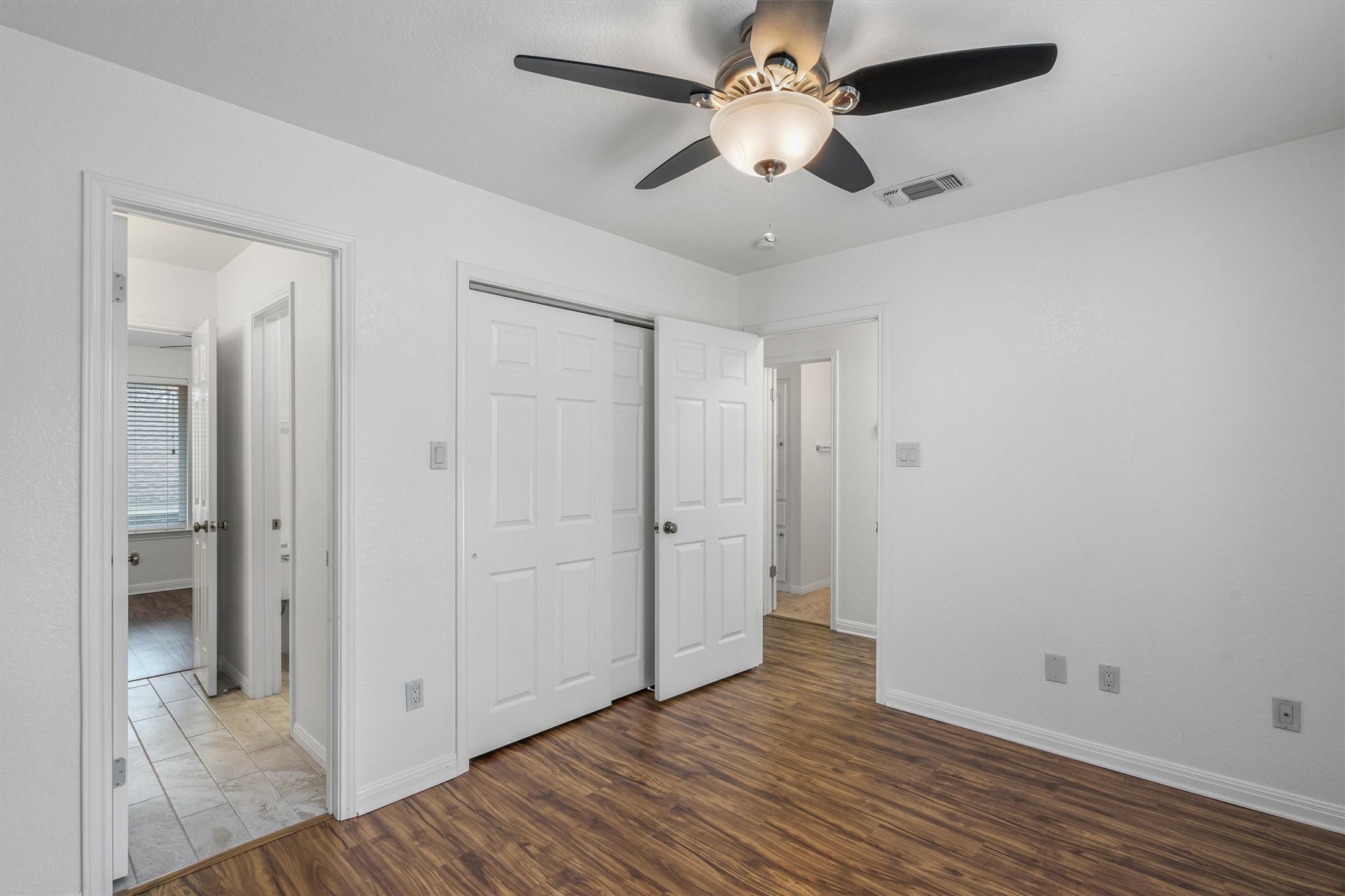 201 East 35th Street, Unit B Austin, TX 78705 - Photo 22 of 27 an empty room with wooden floor and a ceiling fan