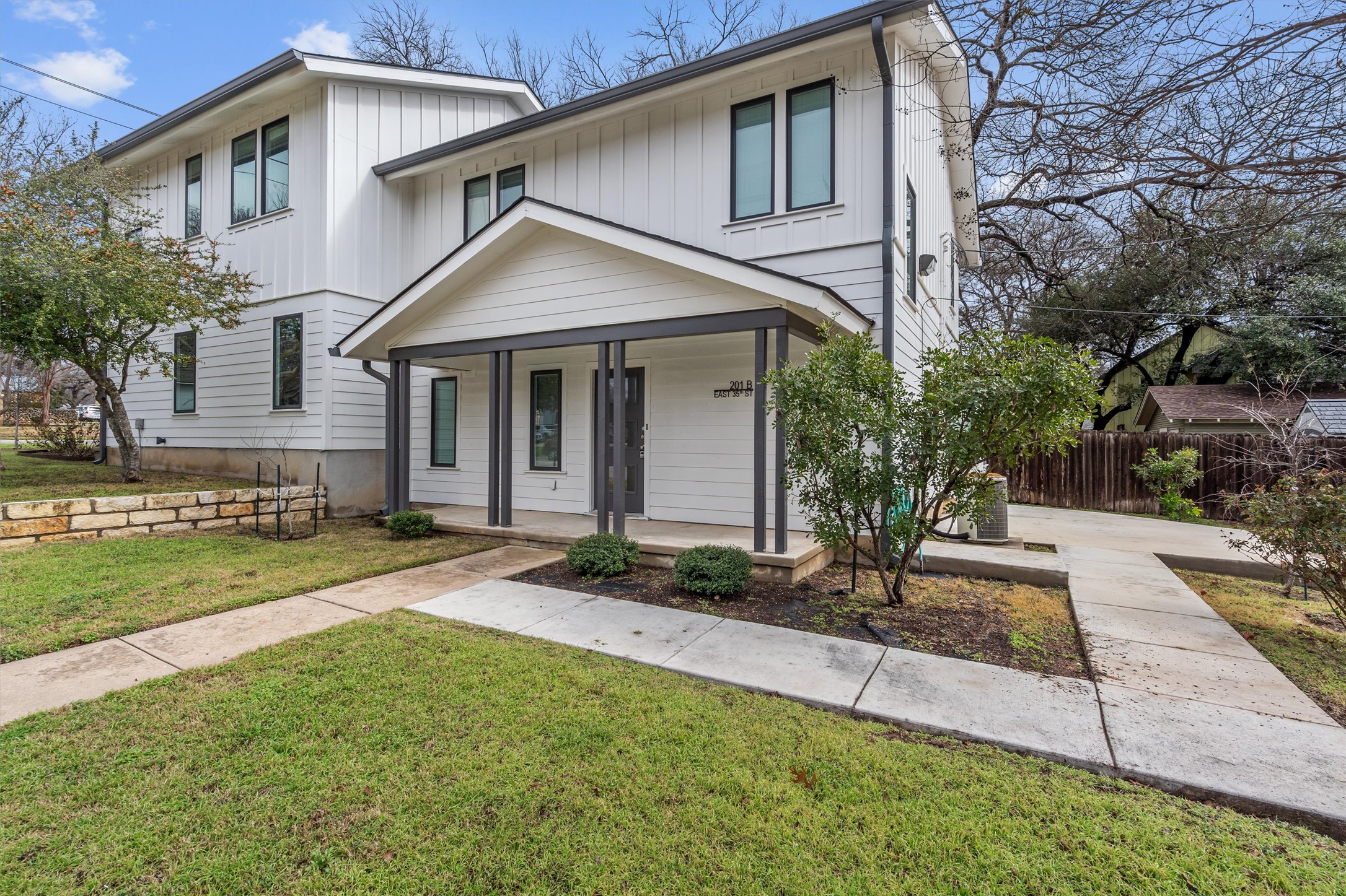 201 East 35th Street, Unit B Austin, TX 78705 - Photo 3 of 27 a front view of a house with a yard and garage