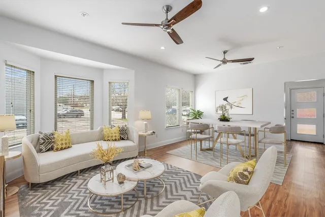 a living room with furniture and wooden floor