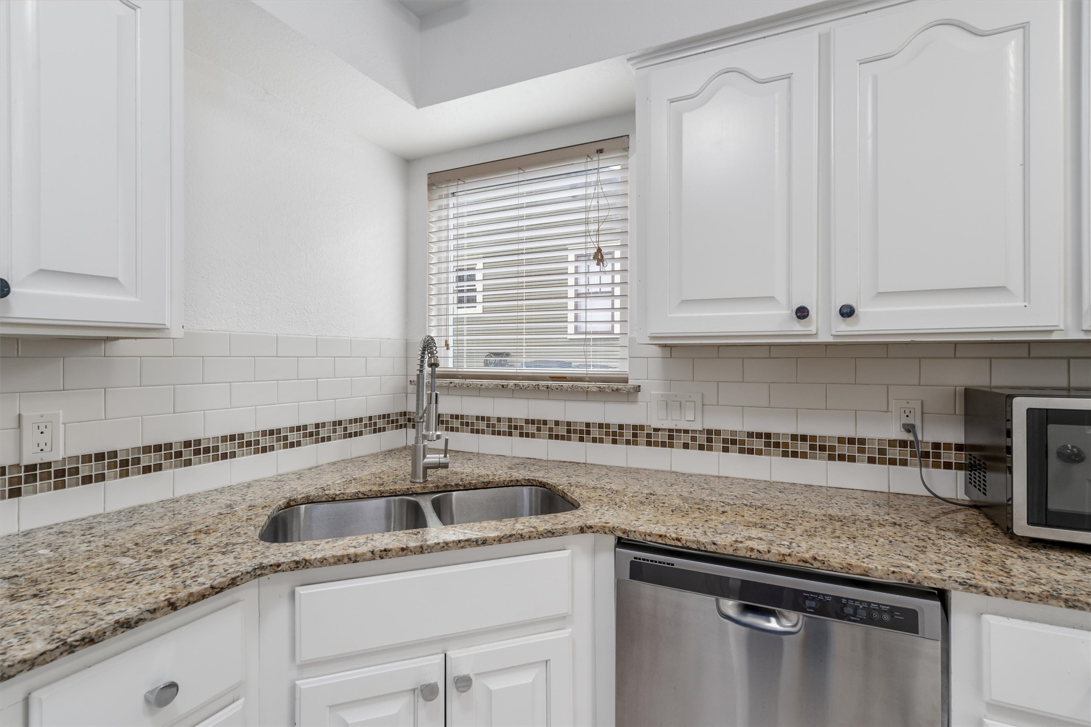 201 East 35th Street, Unit B Austin, TX 78705 - Photo 9 of 27 a kitchen with granite countertop a sink and white cabinets