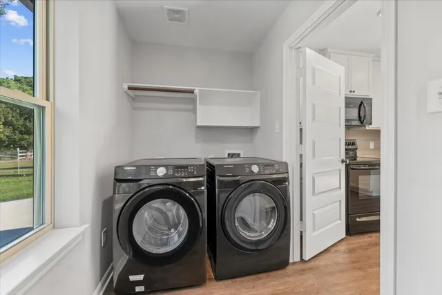 a view of storage and utility room with washer and dryer