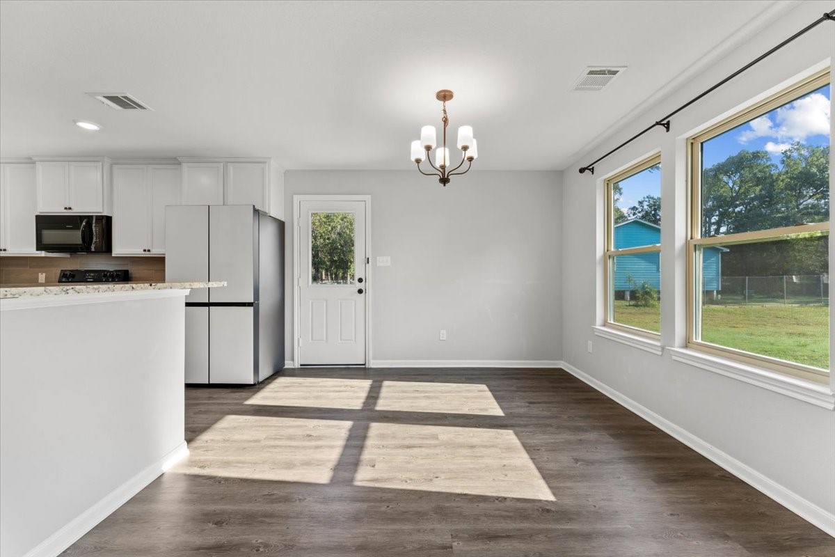 17855 Arbor Oaks Circle New Caney, TX 77357 - Photo 16 of 26 a view of a kitchen with a sink a refrigerator and wooden floor