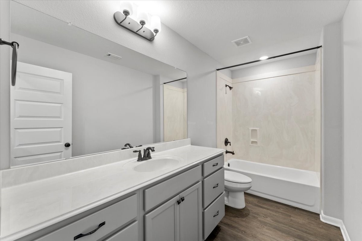 17855 Arbor Oaks Circle New Caney, TX 77357 - Photo 21 of 26 a bathroom with a sink a toilet a shower and a mirror