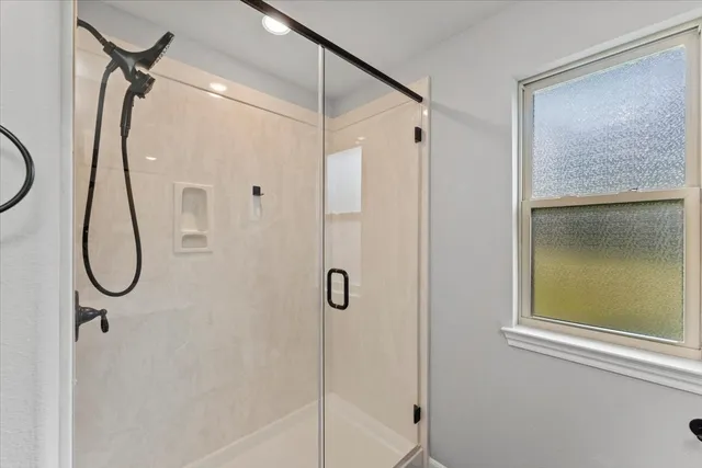 a bathroom that has a glass shower door